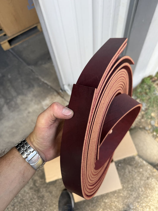 Burgundy latigo strips 1 3/4 inch wide, held by hand