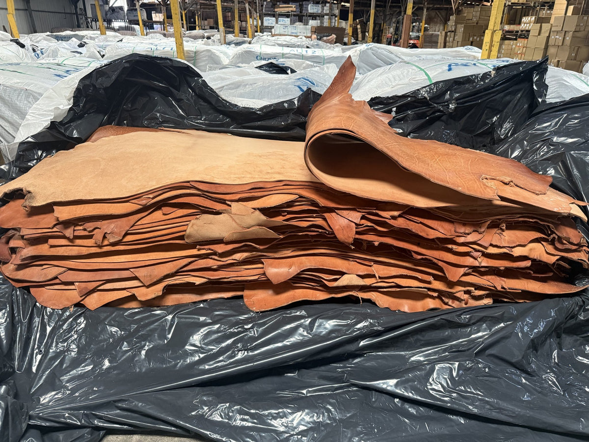 Stack of lightly oiled natural skirting bull sides