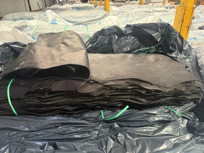 Stack of black rawhide sides at the warehouse